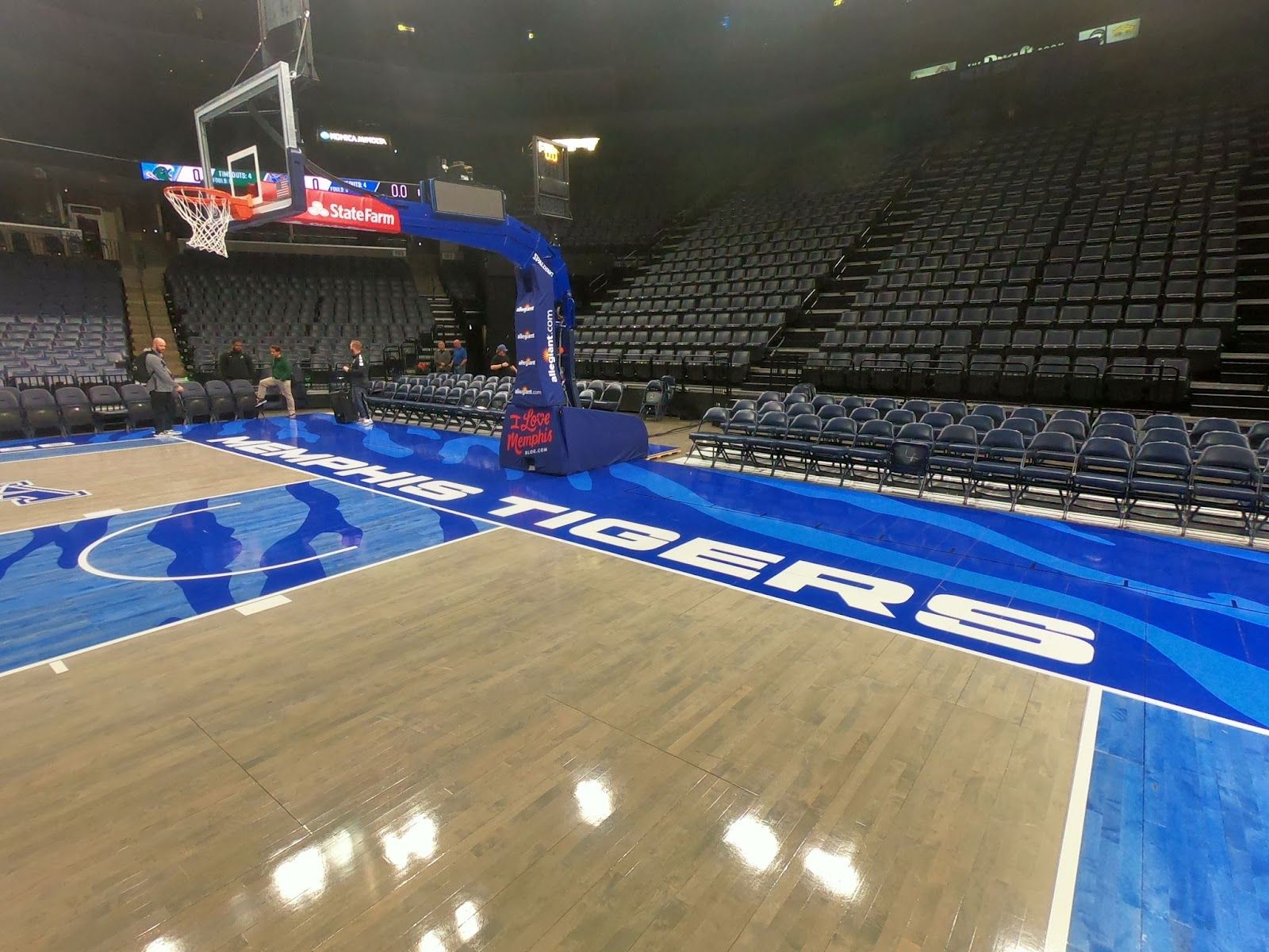 Memphis Tigers basketball court by Sports Floors, Inc. at FedExForum, with a freshly recoated gray-stained hardwood floor, a blue sideline border with “Memphis Tigers” lettering and a blue painted lane under the goal