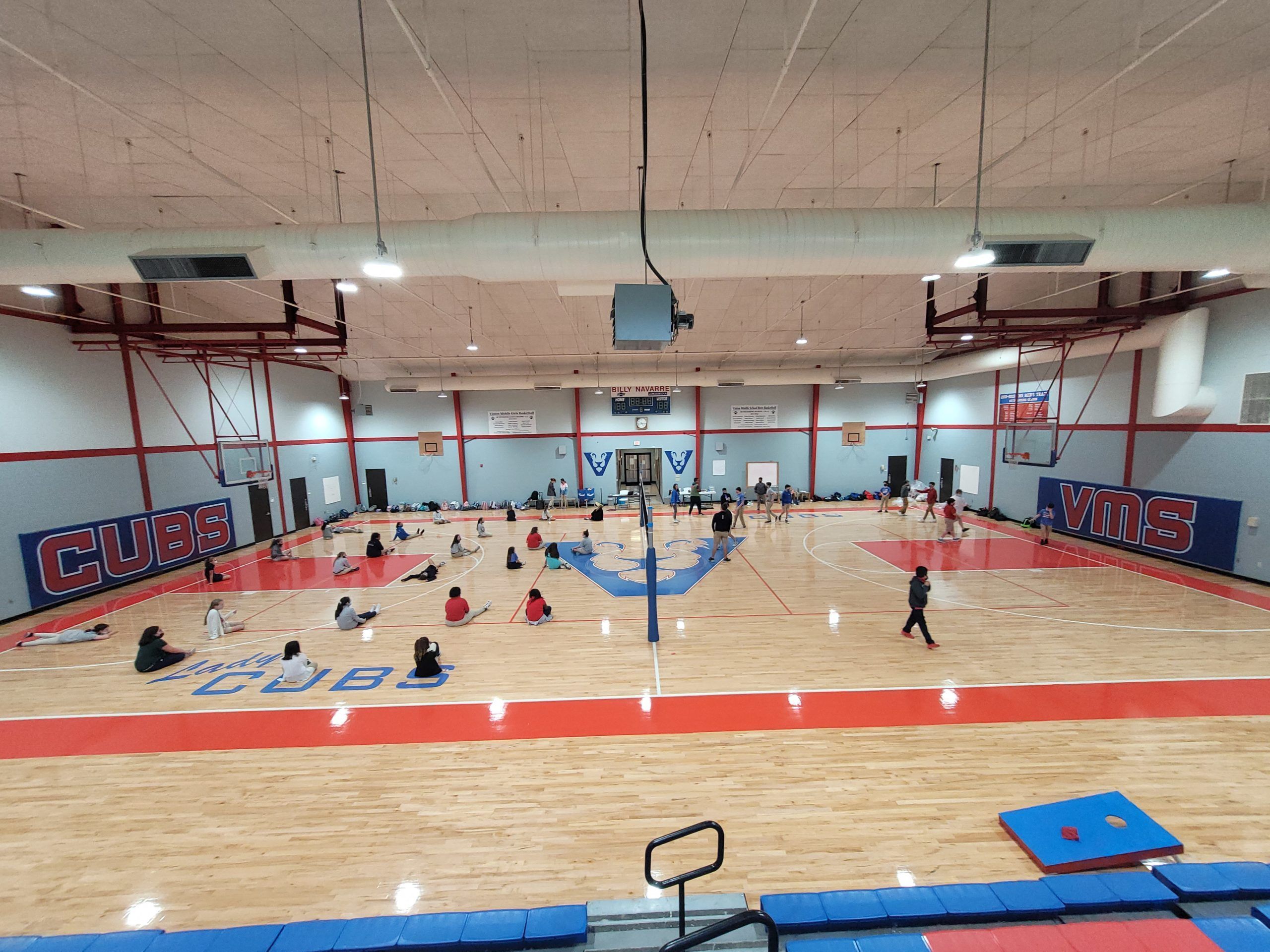 Refinished maple basketball floor in a middle school gym with red and blue game lines, “CUBS” and “VMS” lettering, and a center logo, completed by Sports Floors, Inc. as part of its basketball floor refinishing work in Memphis, TN